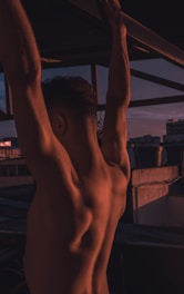 man hanging on a concrete bar