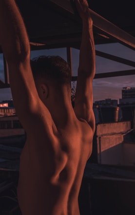 man hanging on a concrete bar