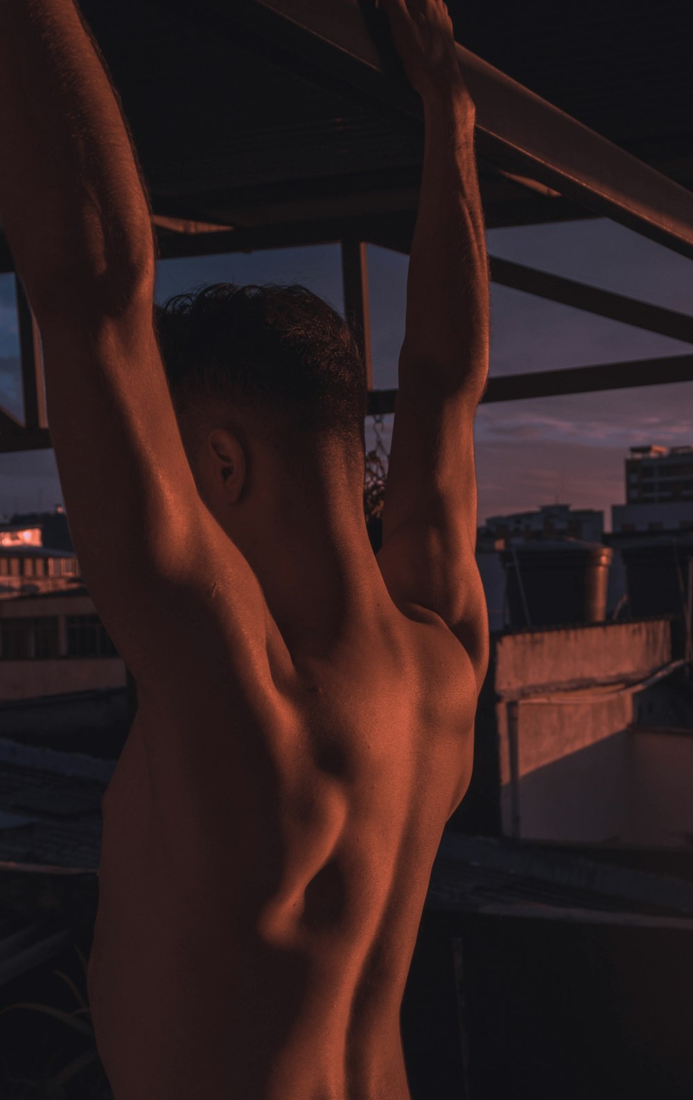 man hanging on a concrete bar