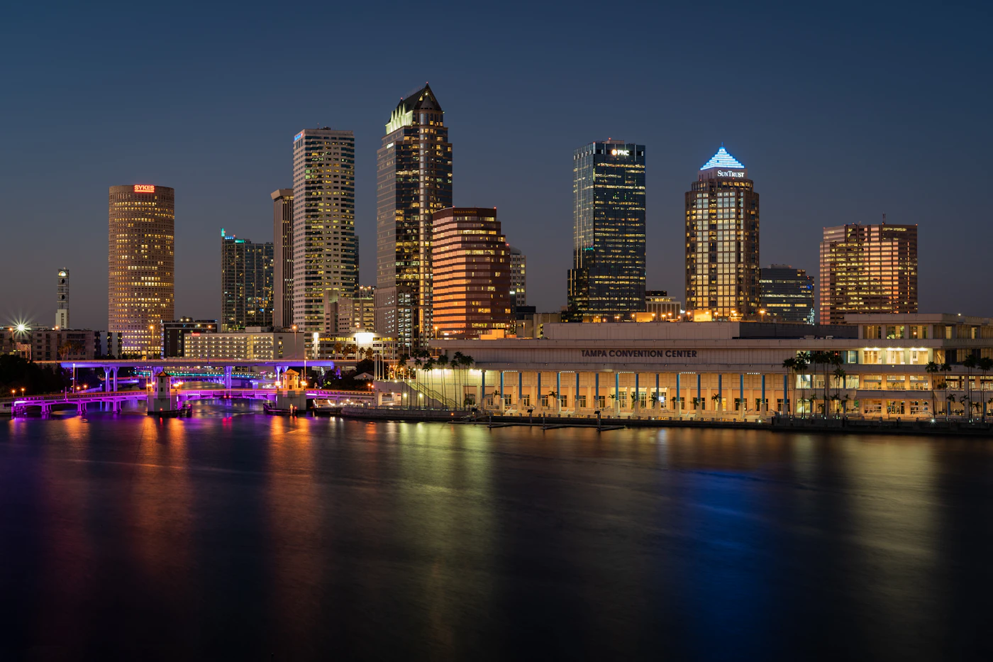 The downtown Tampa skyline lit up at night above the water
