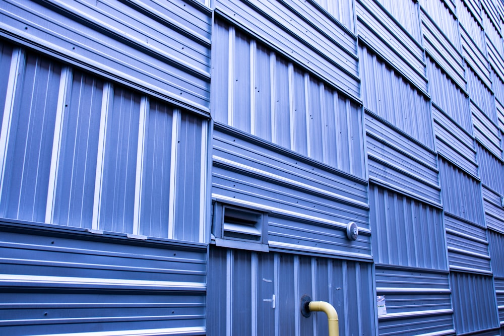 a blue building with a yellow fire hydrant in front of it