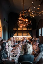 a group of people eating on a long table