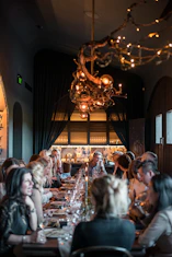 a group of people eating on a long table
