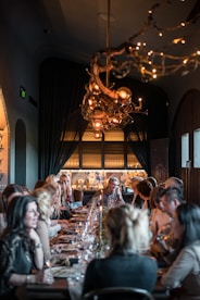 a group of people eating on a long table