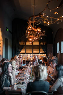a group of people eating on a long table