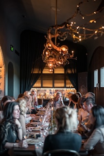 a group of people eating on a long table
