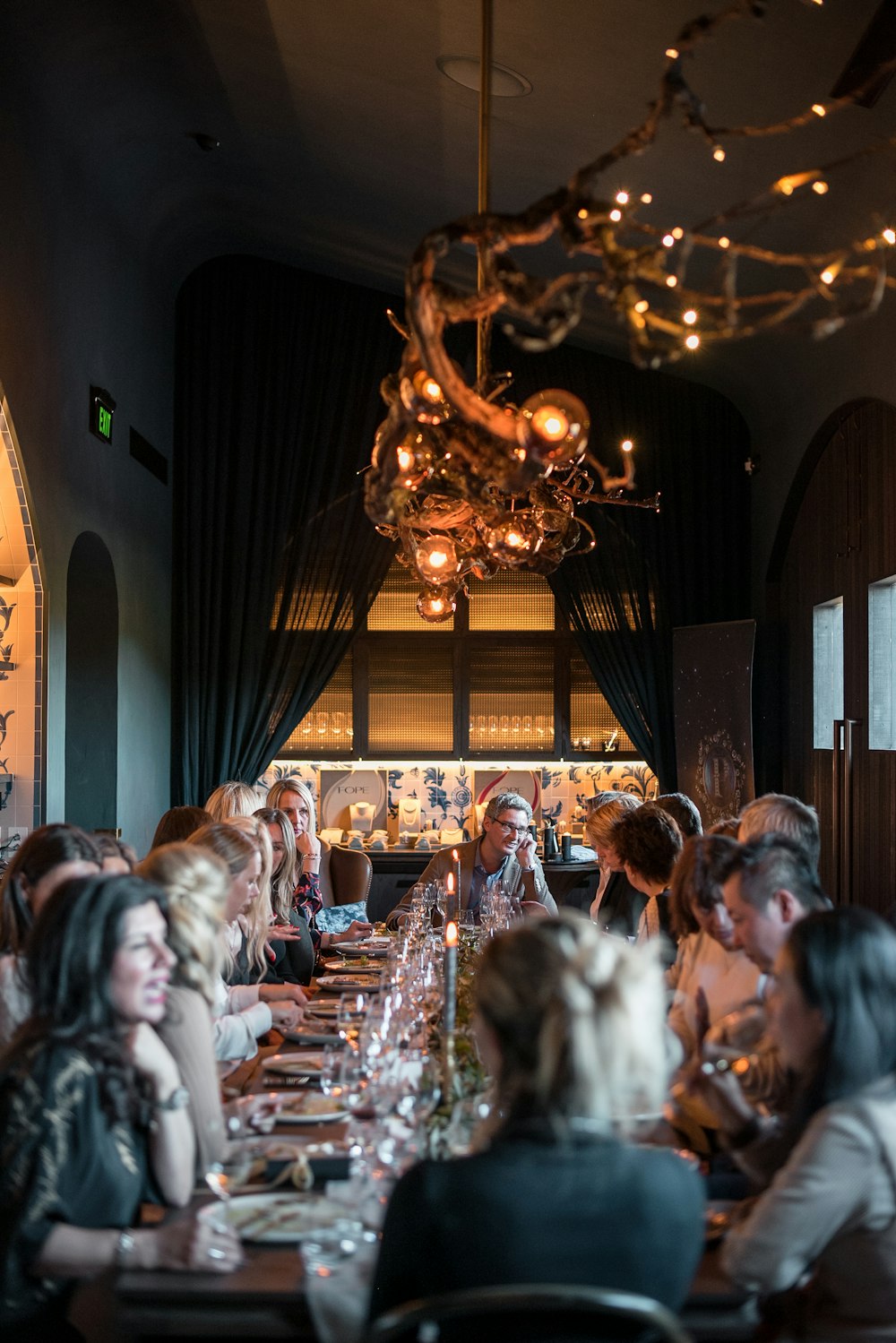 a group of people eating on a long table