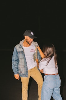 woman taking off man's jacket