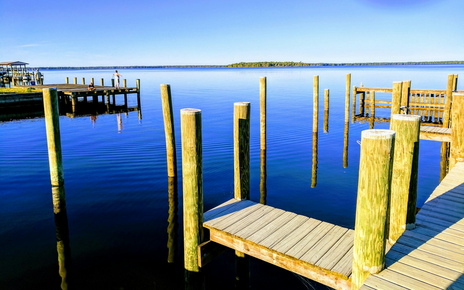 Beige wooden dock near ocean.