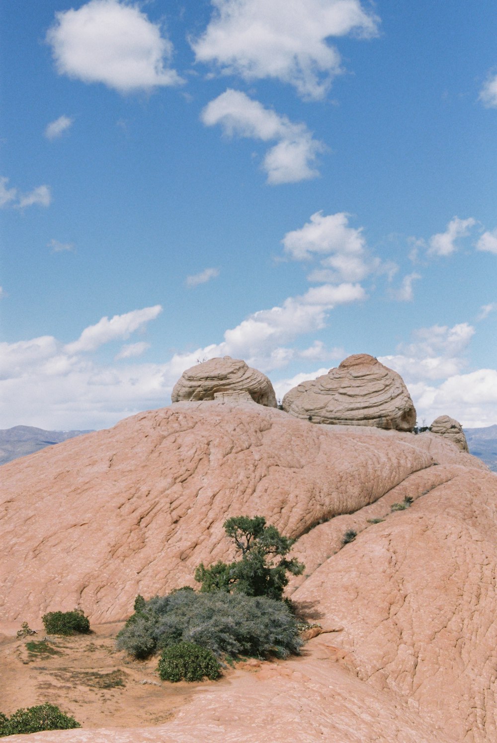 brown rock formation under white clouds