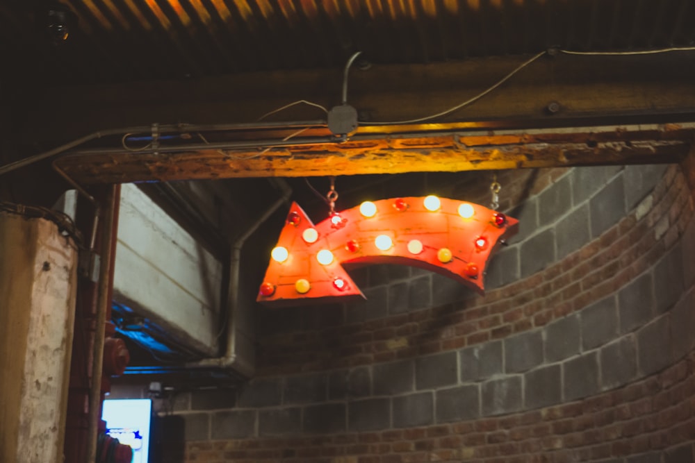 lighted wooden hanging arrow inside building