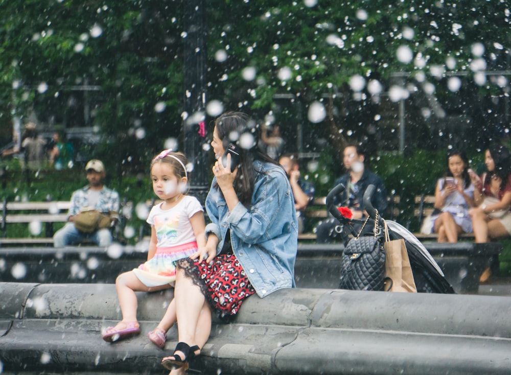 people sitting on benches at the park