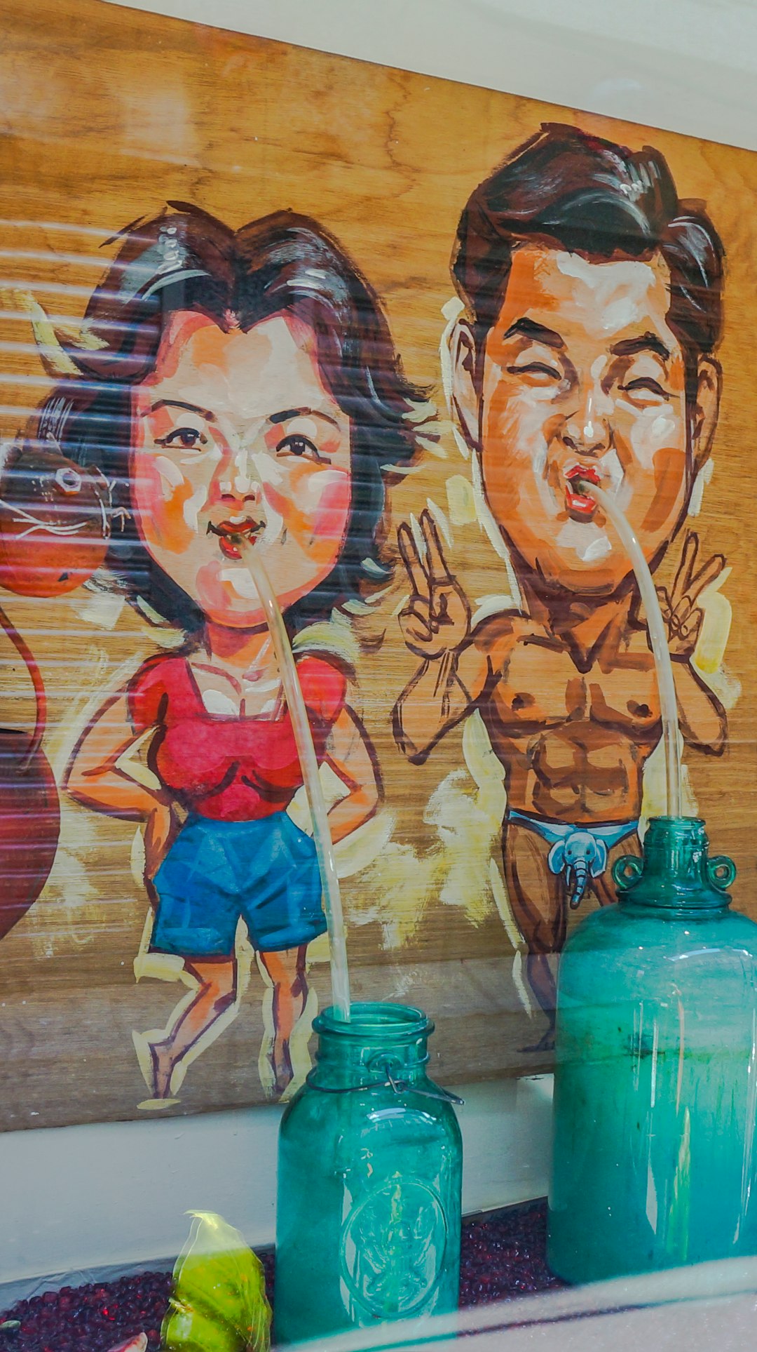 man and woman painted wall with pouring water in green glass container