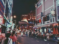 A vibrant city street filled with cultural landmarks and tourists.