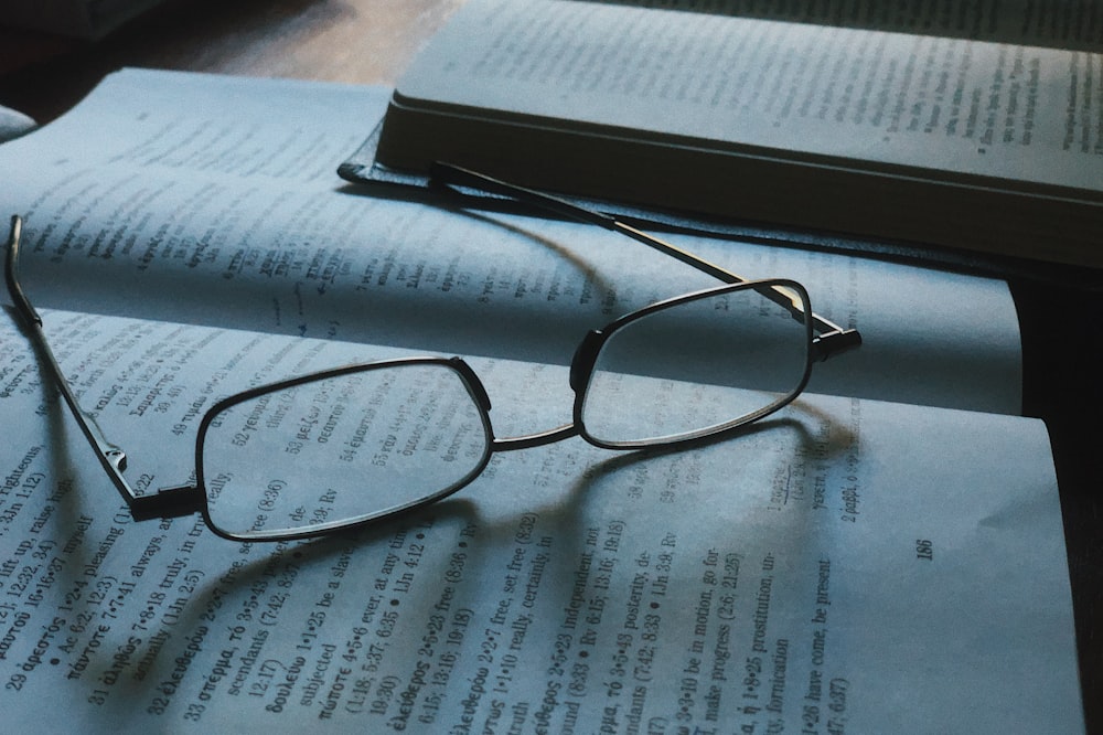 grey framed eyeglasses on book page