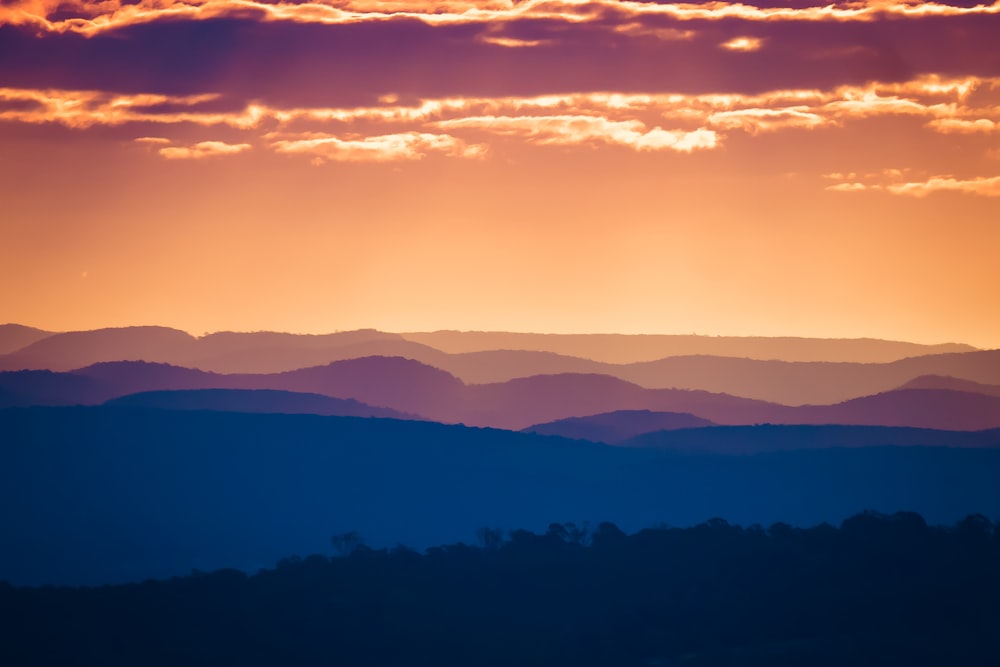 silhouette photography of mountains during golden hour