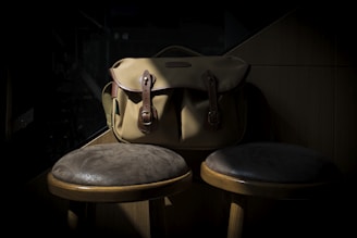Close-up of a stylish leather bag on a wooden table with soft natural light