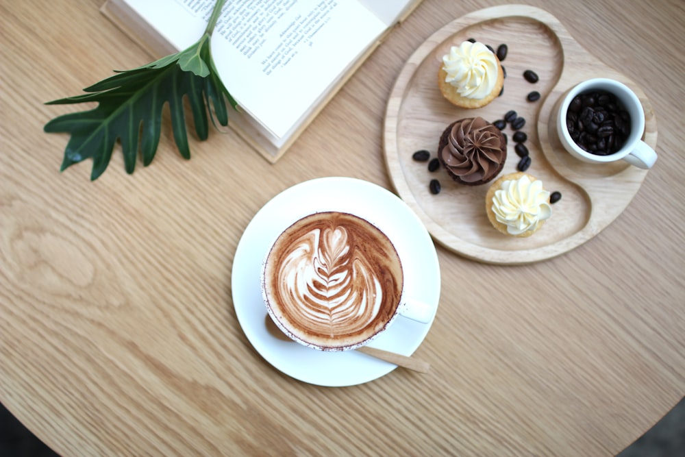 flat lay photography of cup and cupcakes