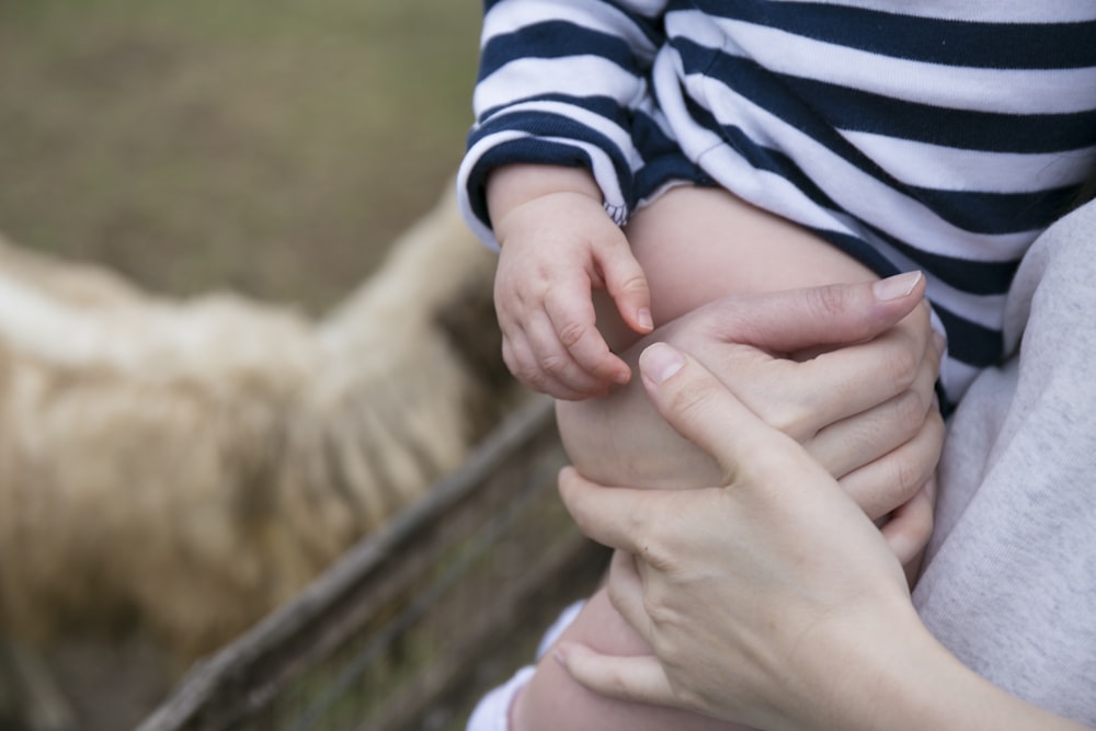 person carrying baby