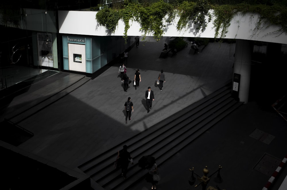 people walking under bridge