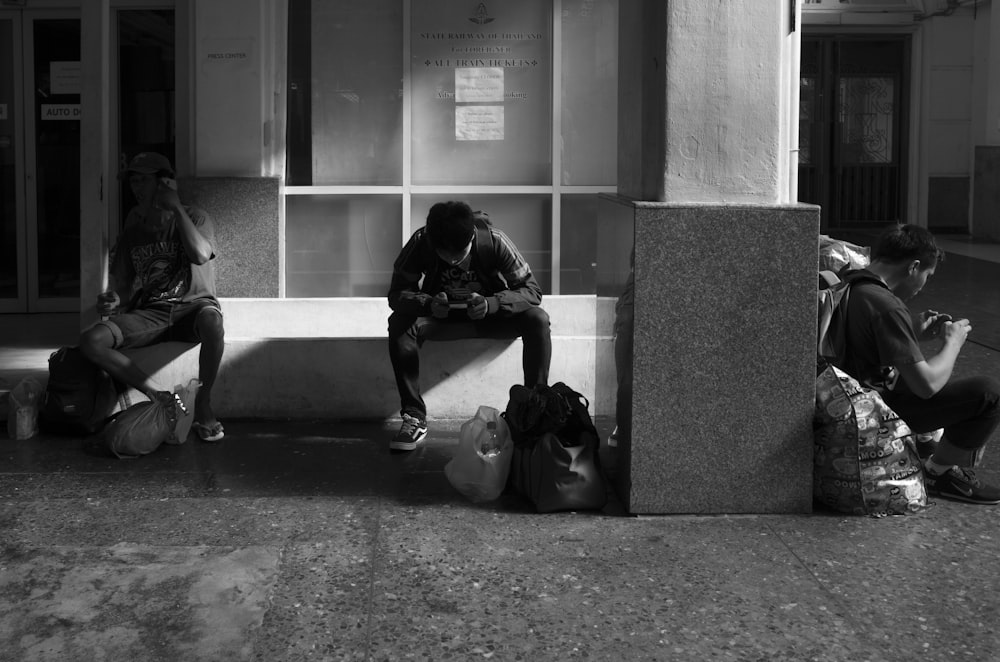 man sitting near wall