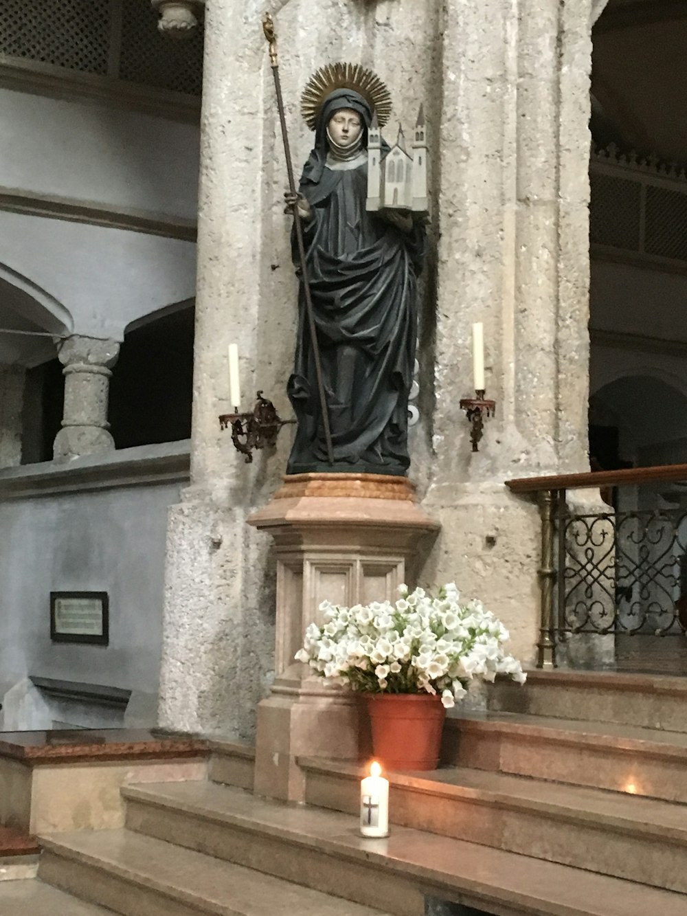 female holding spear religious statue