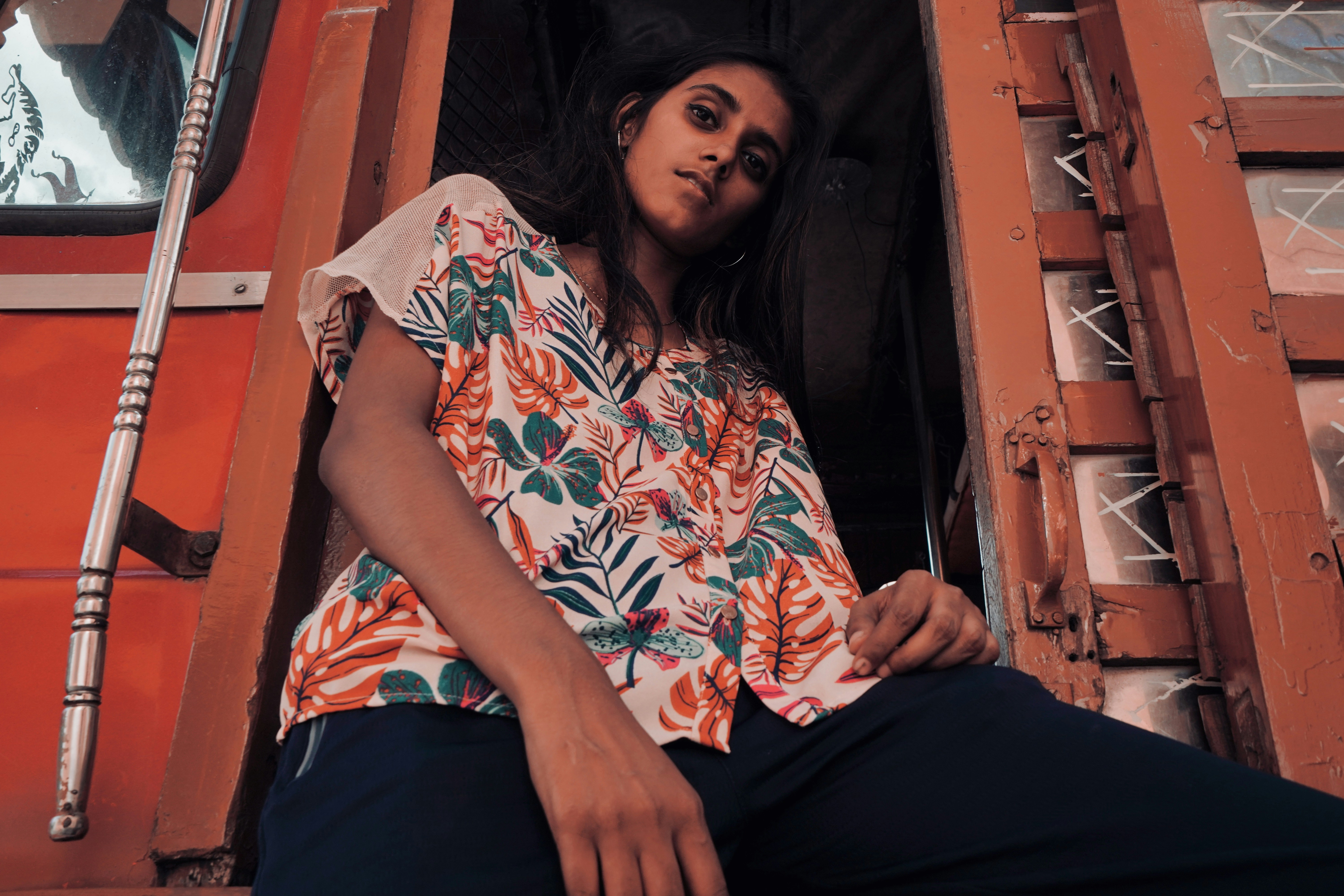 woman wearing blue and red floral button-up T-shirt