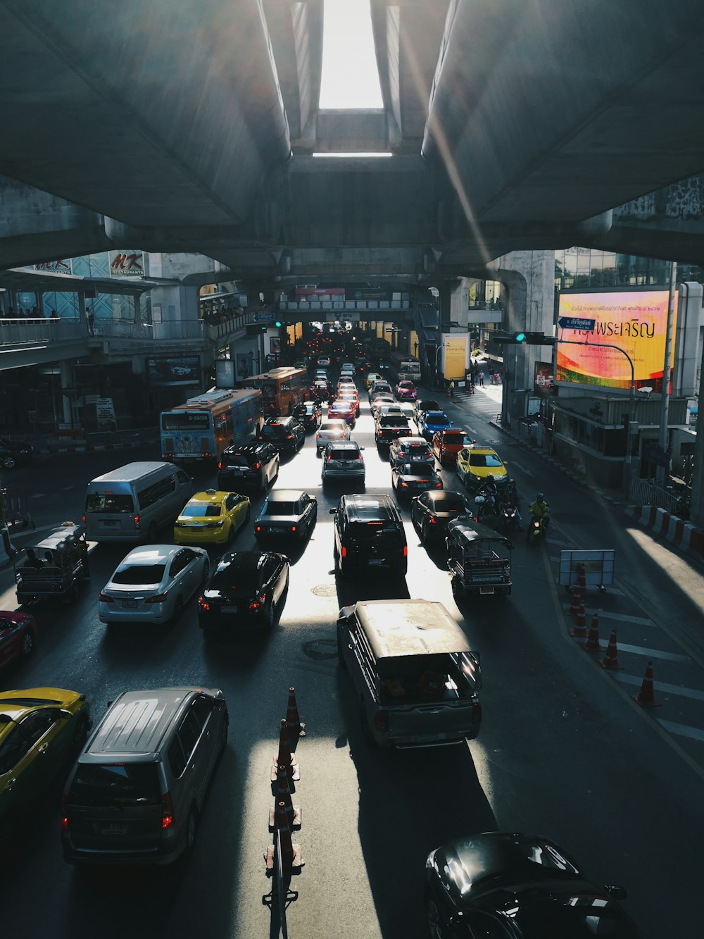 cars under concrete bridge