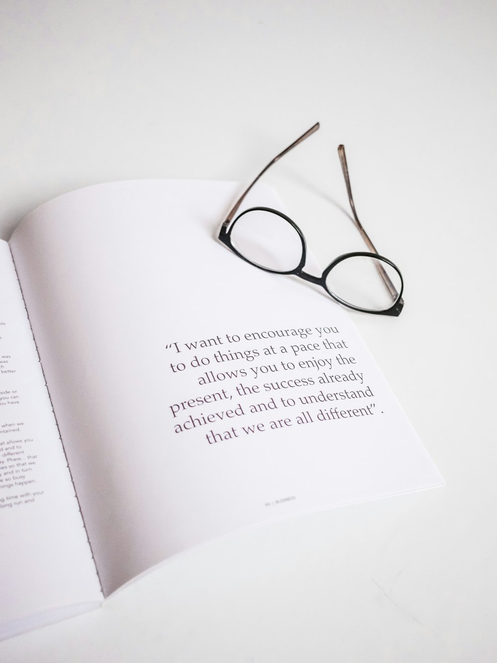 black-framed eyeglasses on opened book