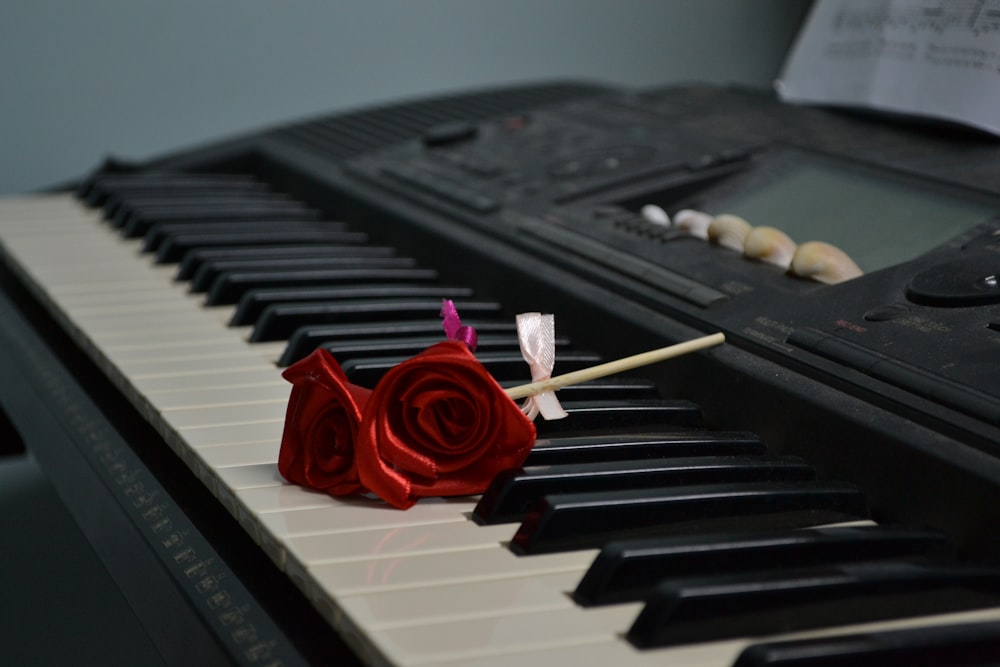 red rose flowers on electronic keyboard