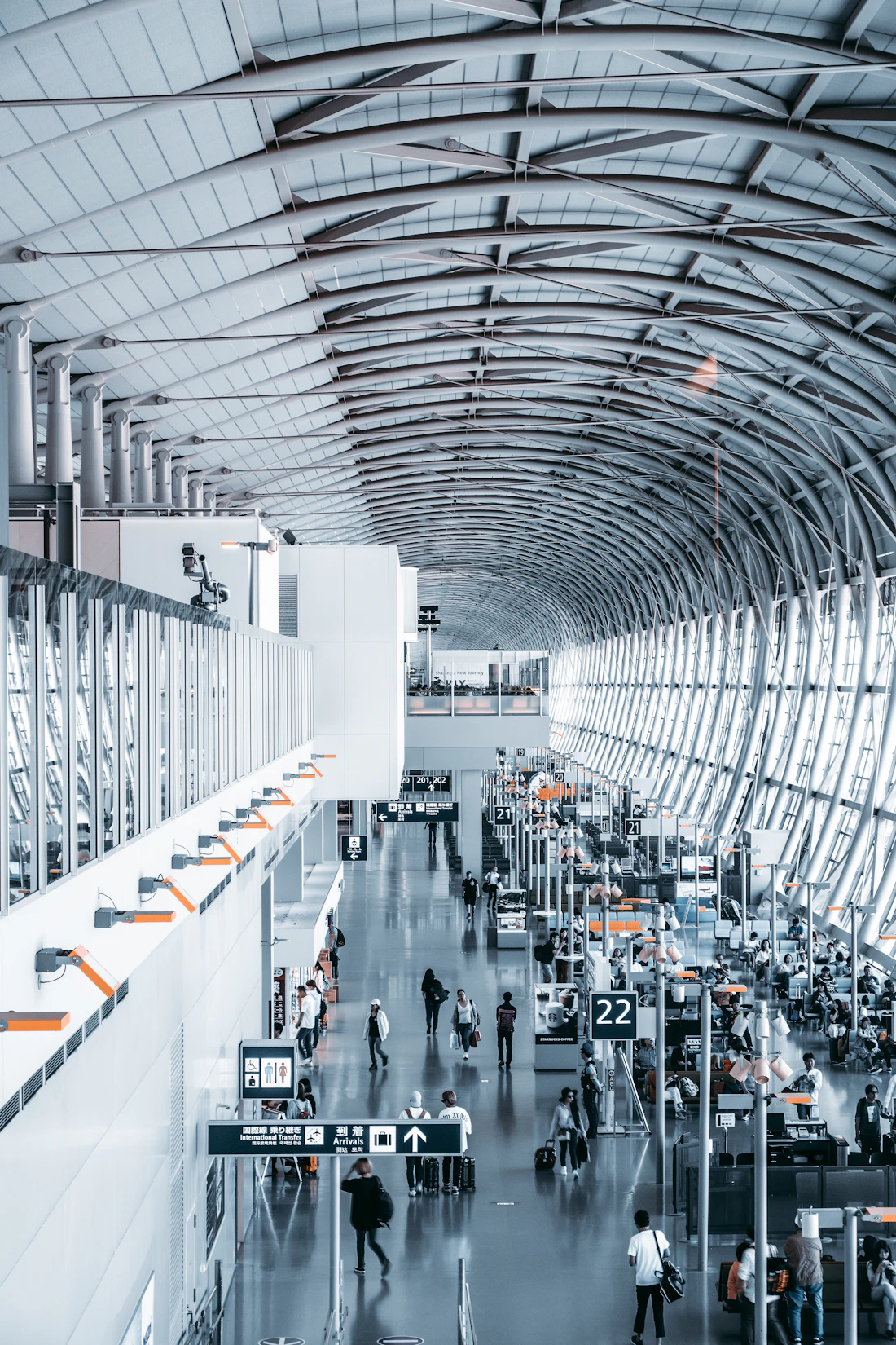 Travellers inside a modern airport terminal
