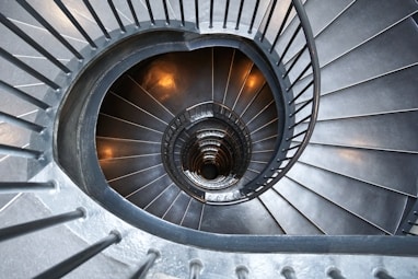 gray concrete spiral stairs with no people