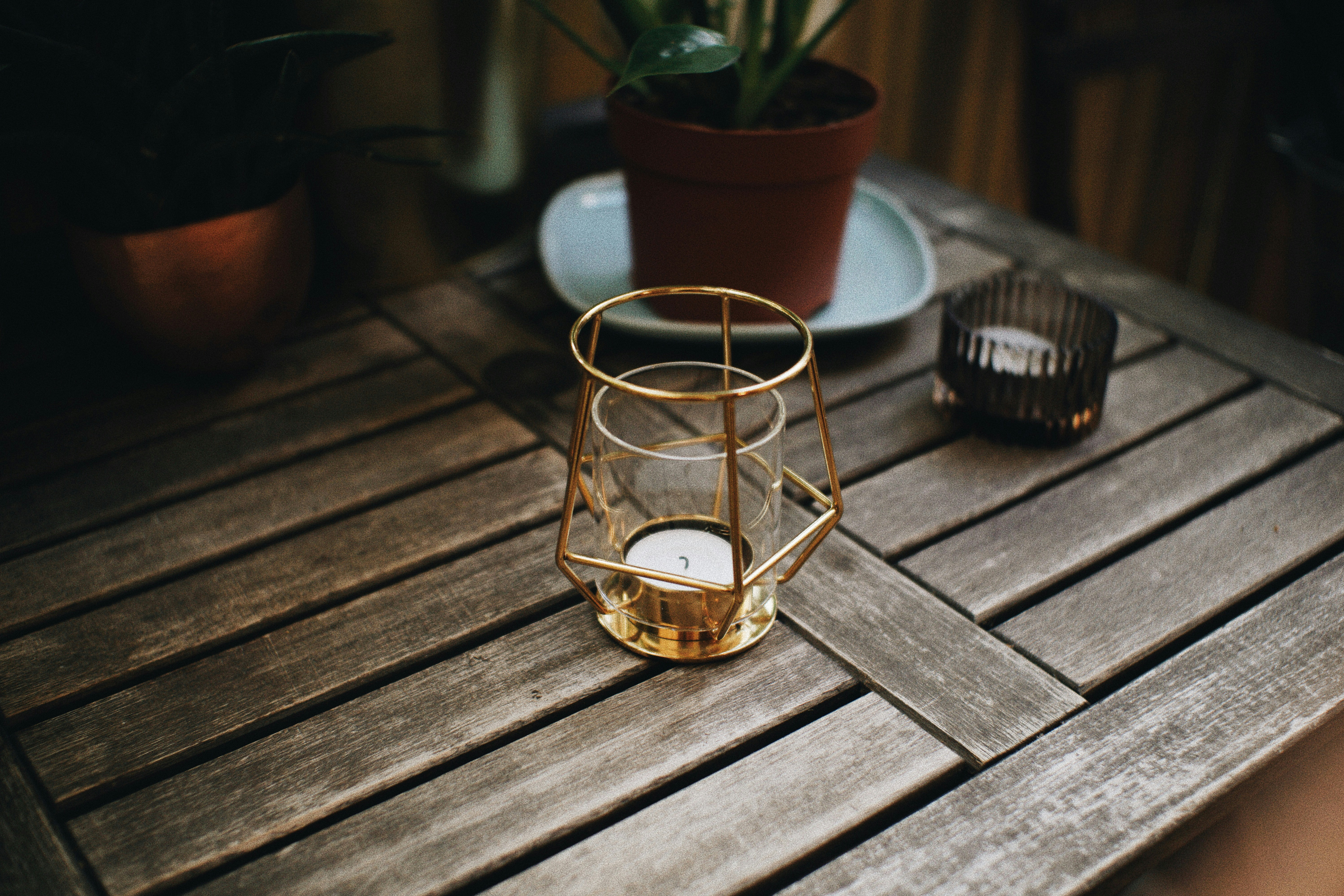 Selective focus photography of candle lantern on table photo Free