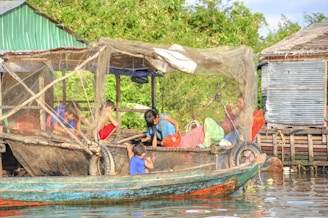 Youth from the community learning sustainable fishing techniques on the eco-safe boat.