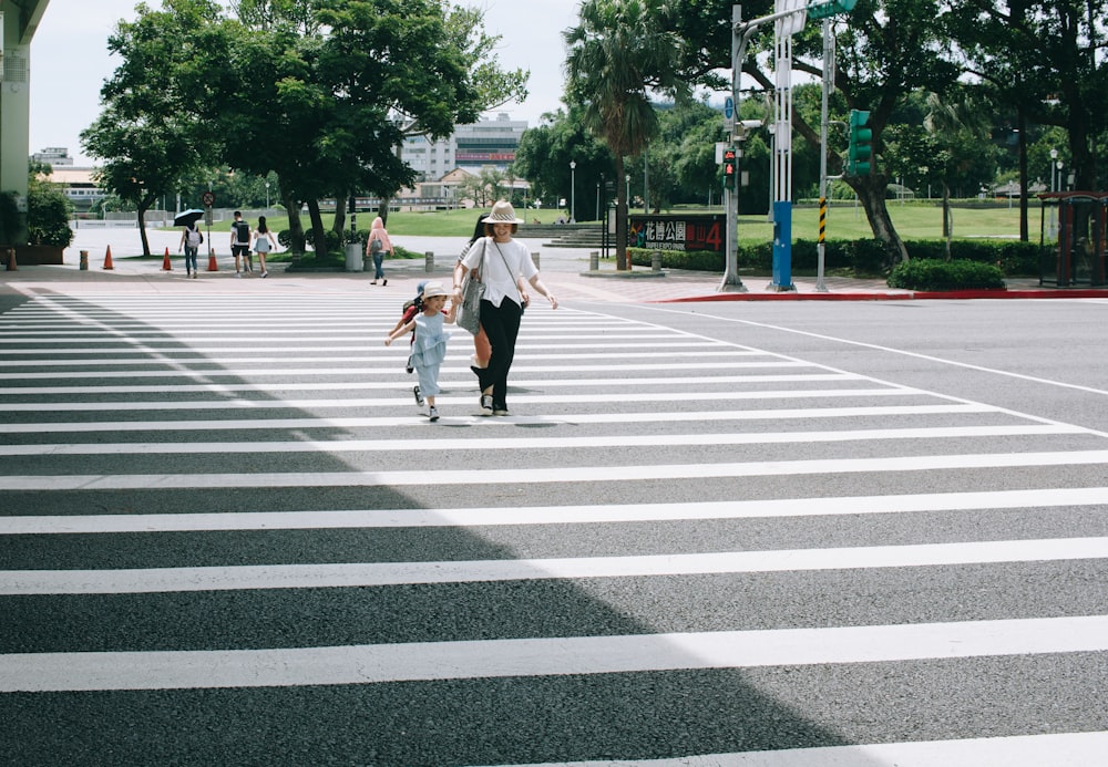 woman and child crossing on pedestrian