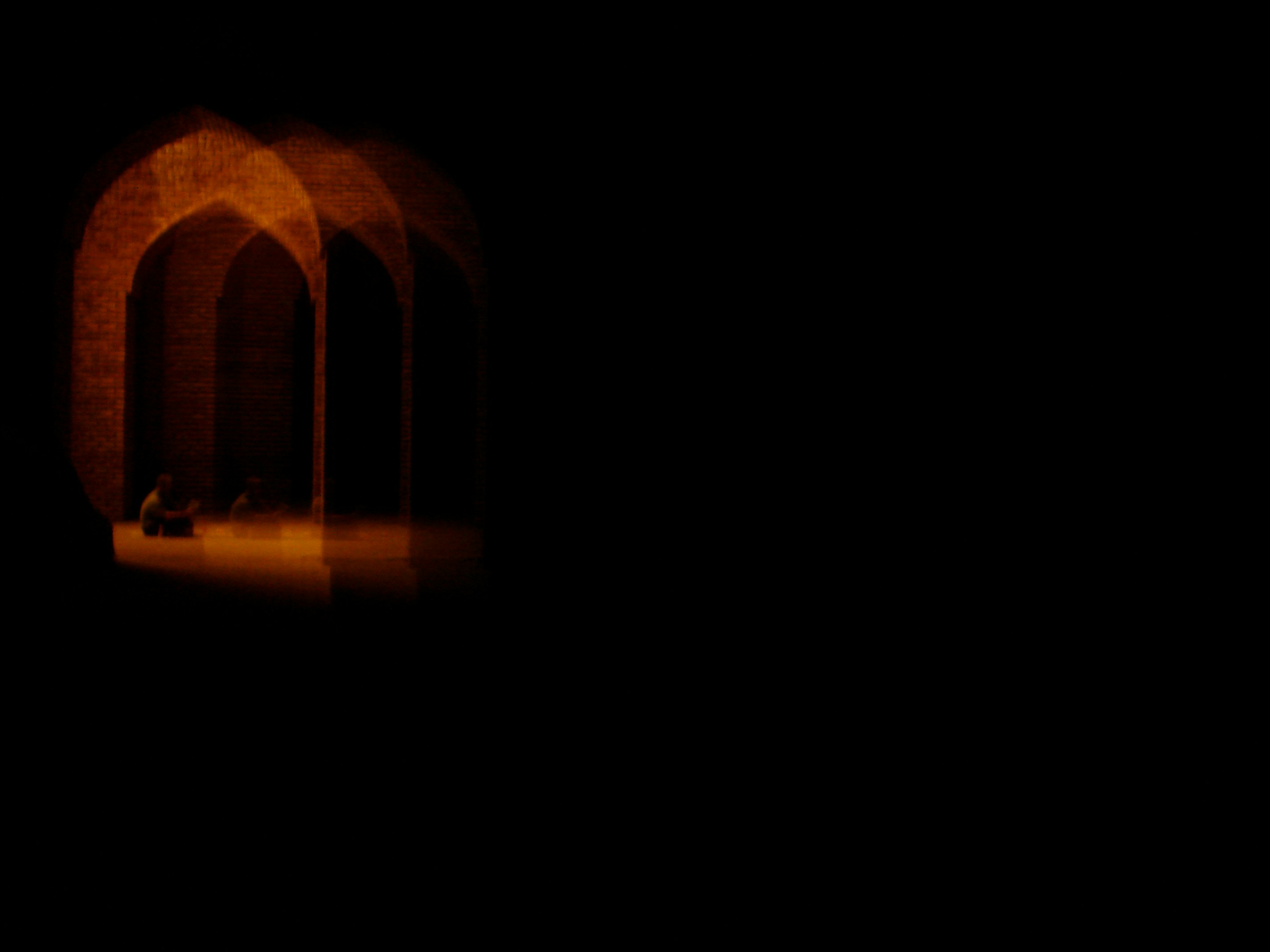 a dark room with a light at the end of it