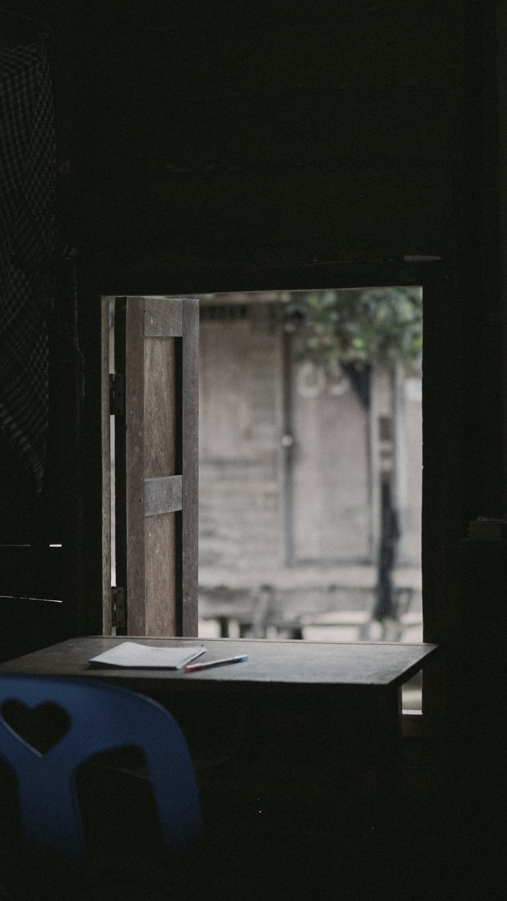 selective focus photography of empty chair beside paper on table