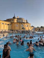 people on pool near buildings