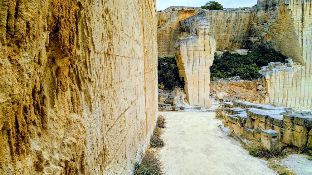 a dirt road between two large rocks