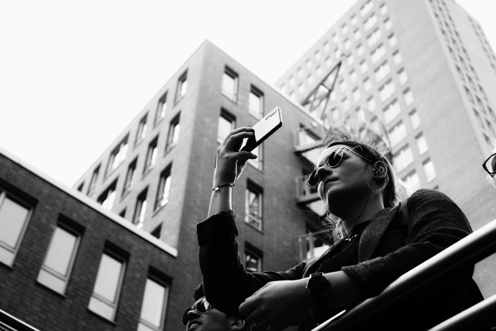 grayscale photography of woman taking selfie