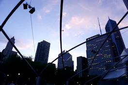 Modern architectural blueprint overlaying a city skyline at sunset, symbolizing strategic investment.