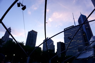 A sleek, abstract cityscape blending London and Lagos skylines under a twilight sky.