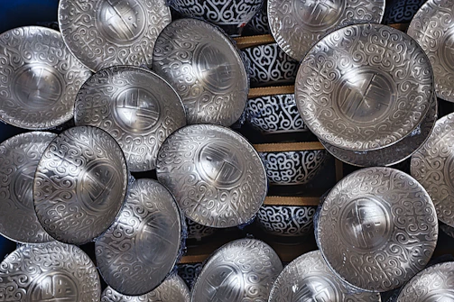 A set of serving bowls in varying sizes stacked neatly, showcasing their polished finishes and timeless design.