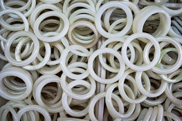 A collection of vibrant jade pieces displayed on natural wood.