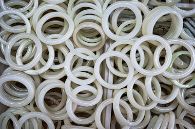 A delicate jade bangle resting on soft pink silk, bathed in gentle morning light.