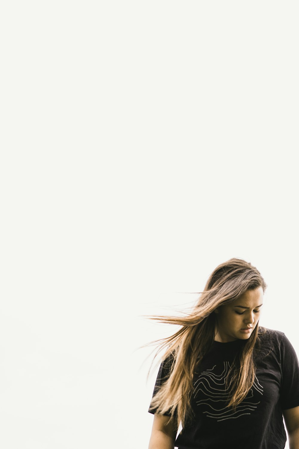 women's black shirt under white sky