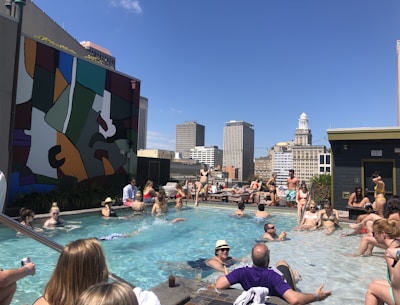 Picture of a condominium pool area with residents enjoying a sunny day.