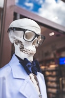 skeleton wearing eyeglasses and blue collared top