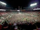 Corporate team celebrating a successful sports event under stadium lights.