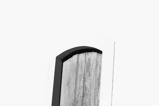 A sleek wooden door with minimalist design, showcasing fine craftsmanship and natural textures.